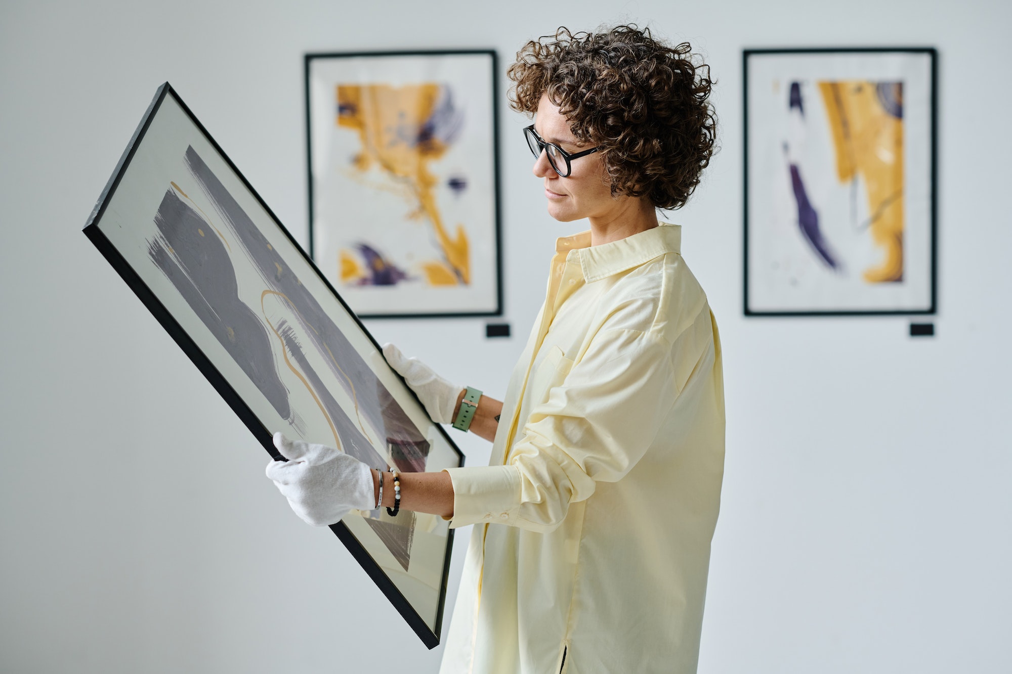 Woman working with art at gallery